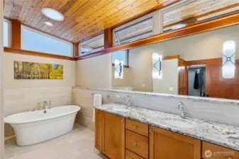 Elegant owner's bath with vessel tub and double vanity is connected to the owner's suite with a large walk-thru closet.