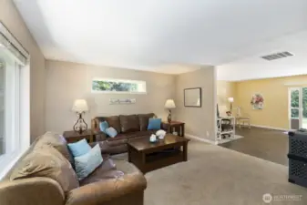 Living room in main home looking into additional living space (currently used as an office) and sliding glass door.