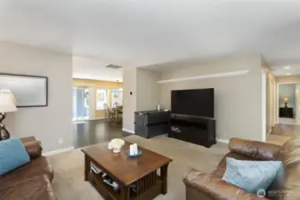 Main living room, hallway to front door and office (could be used as a bedroom) and primary suite.