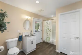 Main home laundry/large storage closet and full bath...exterior door leads to breezeway.