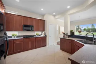 Large kitchen with gas range, upper and lower recipe windows.