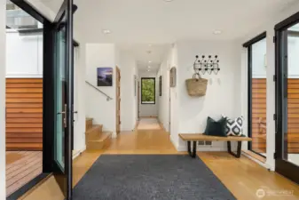 View to the bedroom wing with the front door to the right and garden deck to the left.