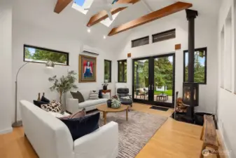 The living room awash in natural light. The room is designed for seamless indoor/outdoor living.