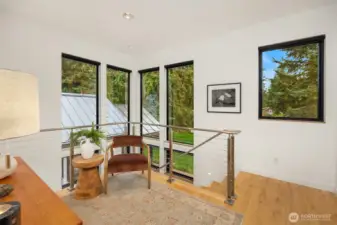 View of the landing in front of the Primary Suite. Note the tall corned windows. This is the perfect spot for a sitting area and/or office.