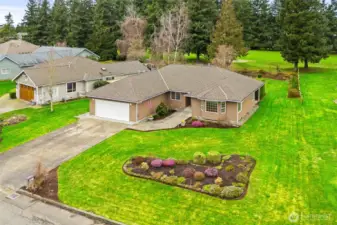 Aerial view showcasing the home's spacious lot, private setting, and proximity to the golf course setting.