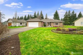 Single level rambler with a spacious driveway, attached 2 car garage, and mature landscaping on a quiet golf course street - 6849 Raspberry Dr.