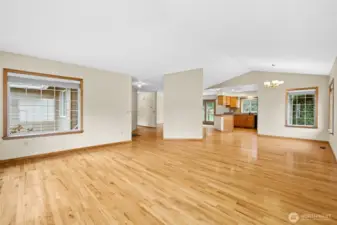 Alternate view of the entry to the left, dining to the right, and kitchen.