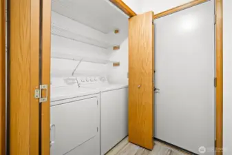 Laundry area with shelving and direct access to the attached 2 car garage.