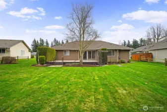 Back of home with expansive lawn backing directly to the golf course fairway.