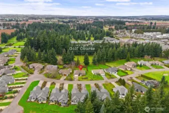 Aerial view showing the home's location backing to the golf course.