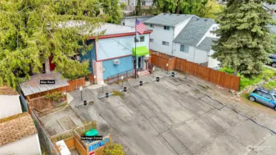 Aerial showing 12 tandem parking spaces, garbage corral, bike rack, and generator corral (to the right along the fence).