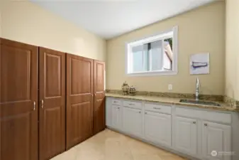 Here is the mud room complete with cabinets, granite, utility sink, lots of storage too!