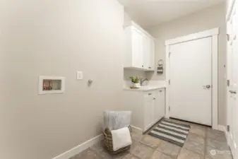 Laundry/utility has an attached 1/2 bath, utility sink and access to the 1 car garage.