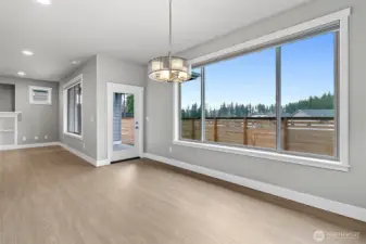Dining area leading to  the fully covered patio with gas fireplace and gas hub for bbq's!