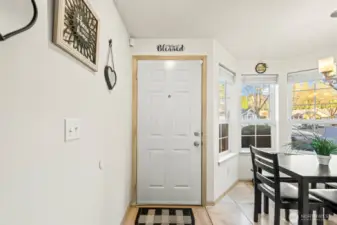 View of front door with kitchen eating nook