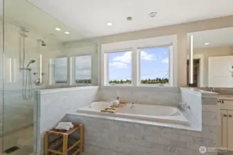 Heated floors, a frameless glass walk-in shower, dual vanities, and a soaking tub with incredible views - this is luxury.