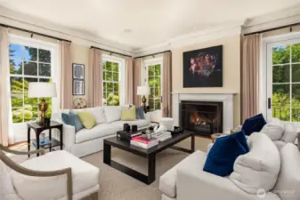 To the left of the entry hall is the formal living room.  Wood burning fireplace, a perfectly scaled room with big windows on 2 sides which flood the room with sunshine.