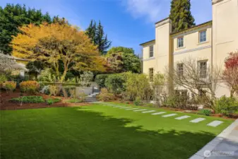 The "lower yard" is to the side of the home and is enormous!  Great for croquet, a play structure, pickleball court and/or a pool if you like! Not visible from the street and gated so that if young kids are playing there they are not able to exit!