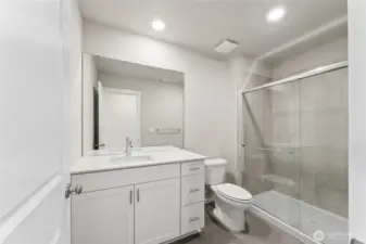 Stylish and functional bathroom featuring a tiled shower with glass doors, sleek vanity, and modern finishes.  Pictures are for representational purposes only, colors and features may vary.