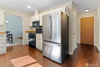 All appliances stay with the home. Pantry is the first door to the right of the refrigerator, and the garage door is at the end of the hallway.