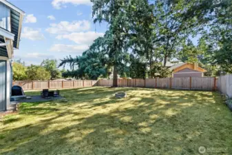Concrete patio is the perfect spot for outdoor grilling and this space offers endless memories around the firepit.