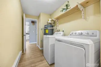 Utility room with newer washer and dryer included.