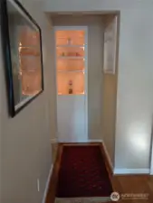 Hallway with lighted built-ins.