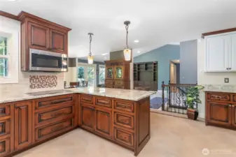 The kitchen has tiled flooring and backsplash.