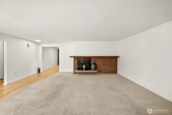 Large, bright living room with wood fireplace.