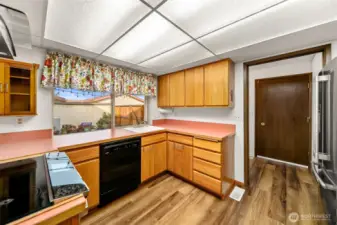 Kitchen with window over-looking the private patio area. Door to garage on the right hand side.