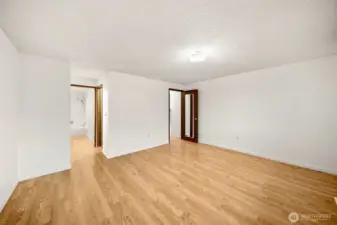 Primary bedroom looking towards the primary bathroom and door to hallway.