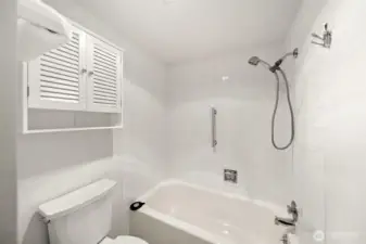 Full primary bathroom with tiled surround.