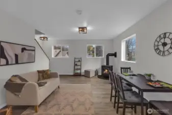 Living room. Lots of natural lighting and cozy gas fireplace. New flooring and trim, new lighting fixtures plus more.
