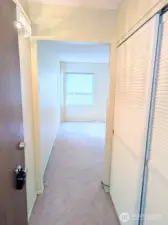 Closet & water heater to the right.  Living area with lots of natural light ahead.