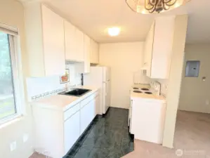 Kitchen with tile flooring, counters & full backsplash.