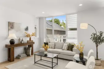 Open-concept living room bathed in natural light from large-format windows.