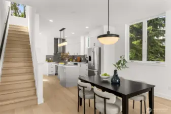 Gourmet kitchen featuring crisp white cabinetry, quartz countertops, and premium stainless steel appliances.