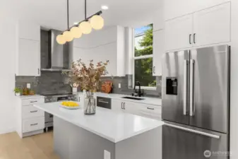 Chef’s kitchen view highlighting the functional island with bar seating and elegant pendant lights.