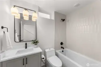 Secondary bathroom showcasing clean lines, a full tub, and contemporary finishes.
