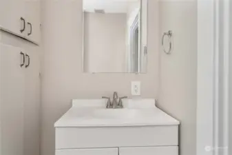 Full bath with vanity downstairs servicing two bedrooms