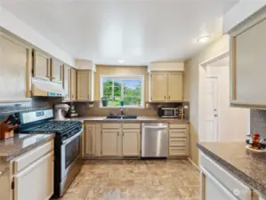 Well appointed kitchen with stainless appliances and ample storage and counter space.