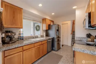Elegant granite-tiled countertops complemented by classic Shaker-style cabinetry