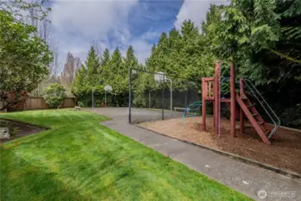 Beautifully landscaped grounds with mature trees and a dedicated playground area