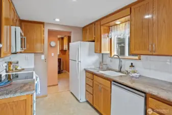The open galley kitchen features a window over the seat . . .