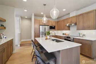 Photos of the staged model home with the same floorplan and similar finishes.