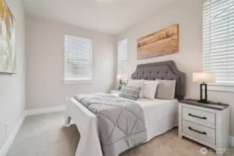Photos of the staged model home with the same floorplan and similar finishes.