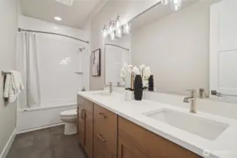 Photos of the staged model home with the same floorplan and similar finishes.