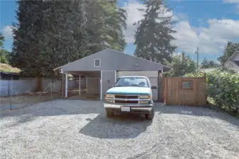 Parking at the end of the building. The fence is the gated entrance to the front of the building
