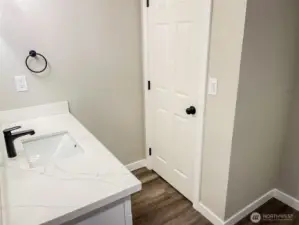 DOWNSTAIRS BATH...COMMODE BEHIND DOOR