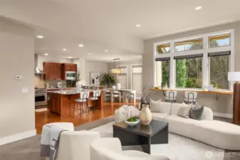 Living area opens to the kitchen, dining area and upper deck